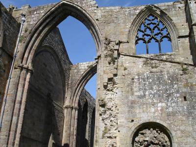  photo of the arches windows in a ruined medieval abbey on a sunny day