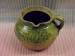 a jug made from green glazed pottery