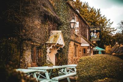 photo of a pub on a leafy street